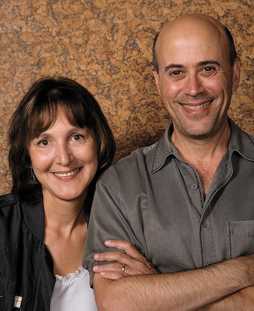 Lyne Greene holding Richard Levine's arm in headshot