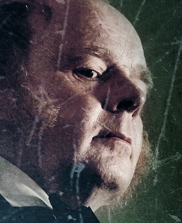 Jason Watkins Headshot looking down with a serious expression