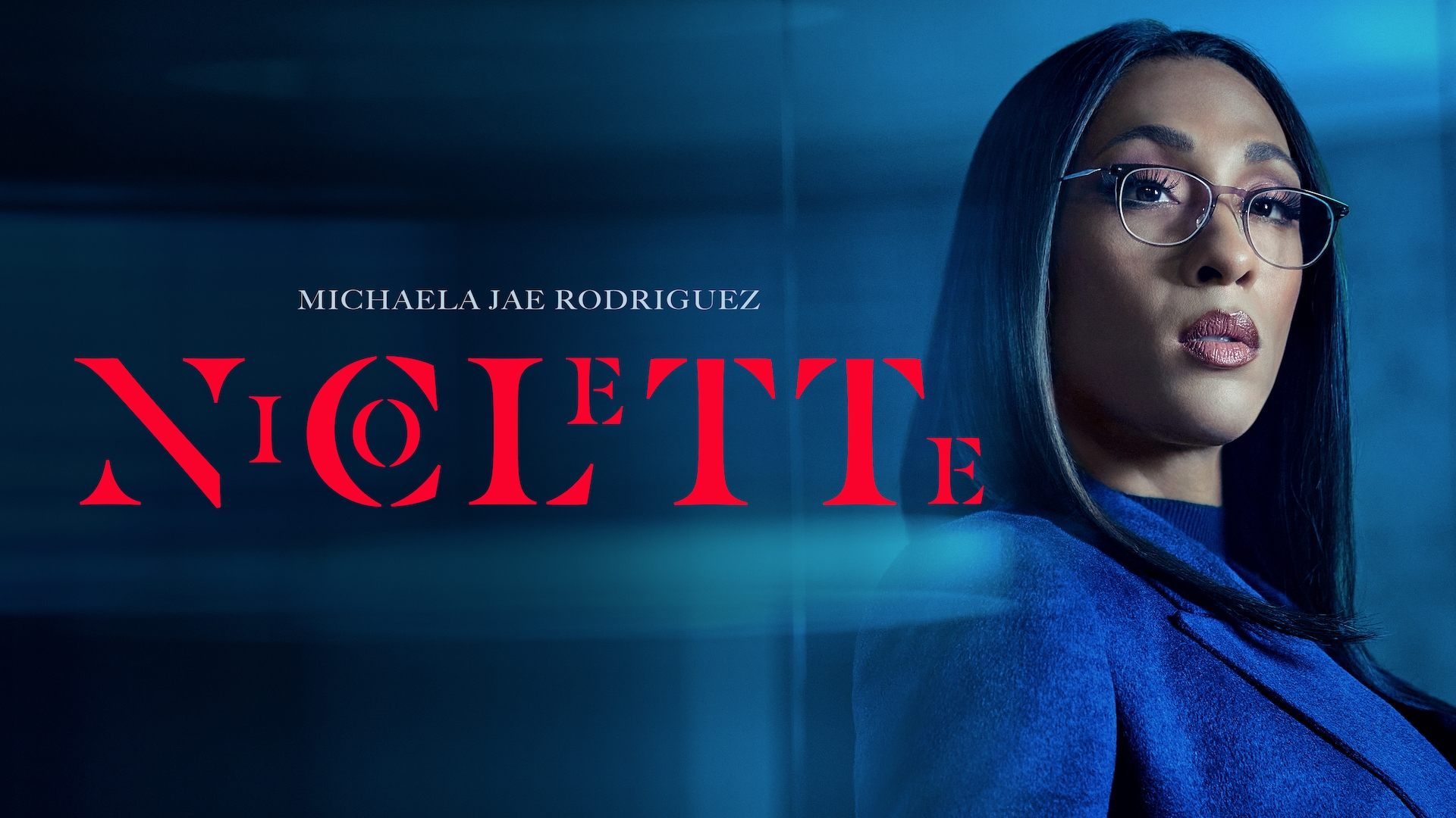 Michaela Jaé Rodriguez headshot wearing glasses and a navy jacket for AHS: Delicate