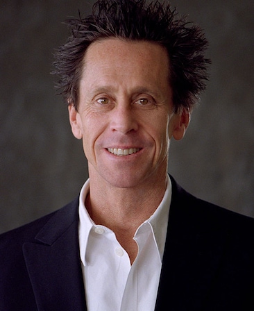 Brian Grazer headshot in white button down and black suit in front of textured marbled dark grey background