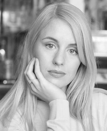 Louise Shore Headshot with her hand on her chin in a black and white filter