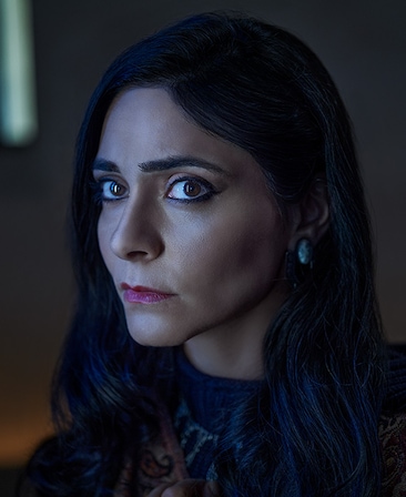 Pegah Ferydoni headshot wearing a black top 