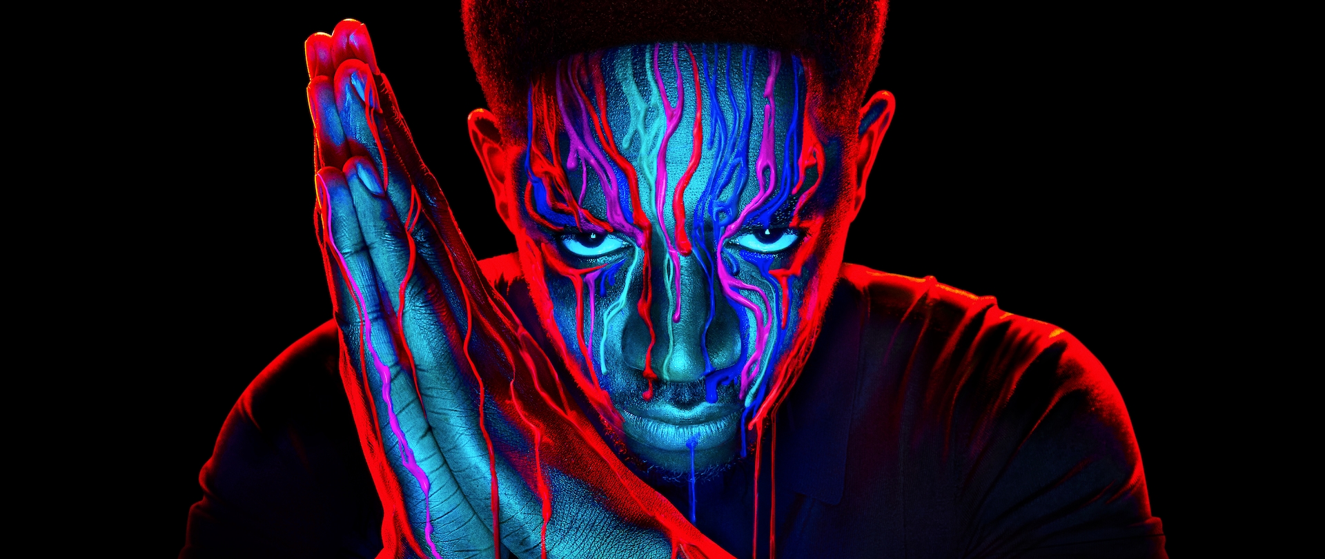 Close up of Franklin Saint with red and blue paint dripping down his face for FX's Snowfall.