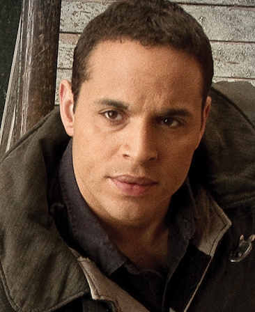 Daniel Sunjata headshot wearing a black fire jacket