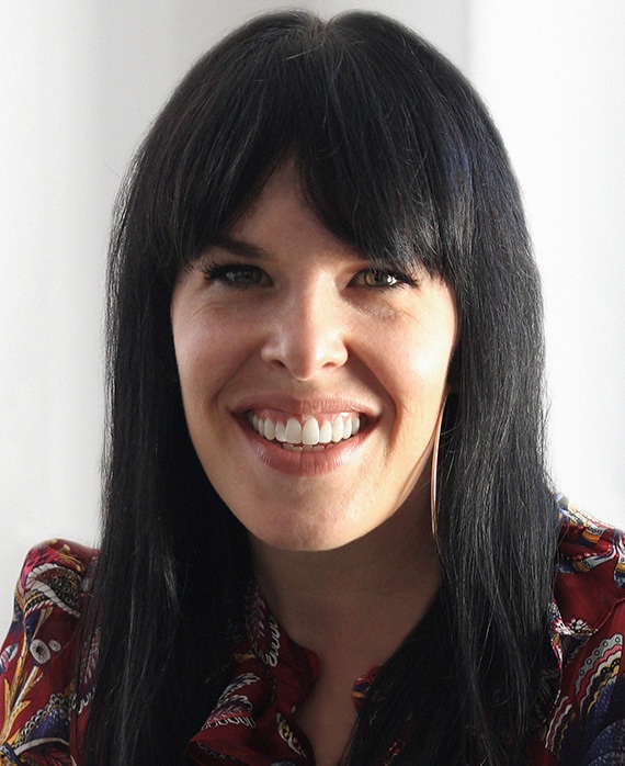 Alexis Martin Woodall headshot wearing a red patterned shirt