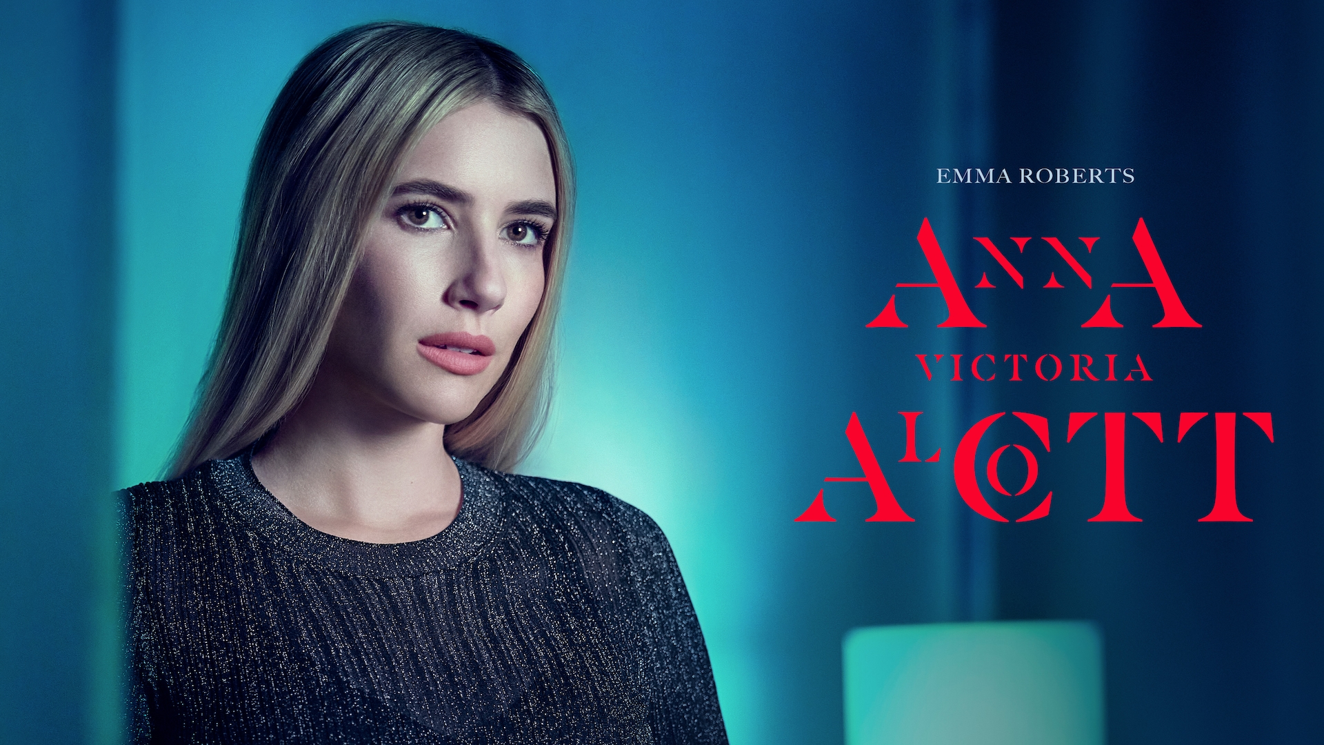 Emma Roberts headshot wearing a gray knit top standing against a blue background for AHS: Delicate