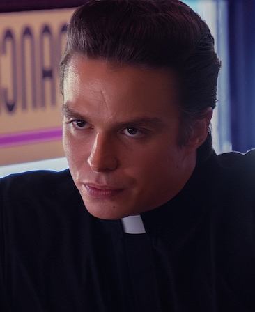 Nicholas Alexander Chavez as Father Charlie Mayhew in FX's Grotesquerie in a clerical collar and black attire.