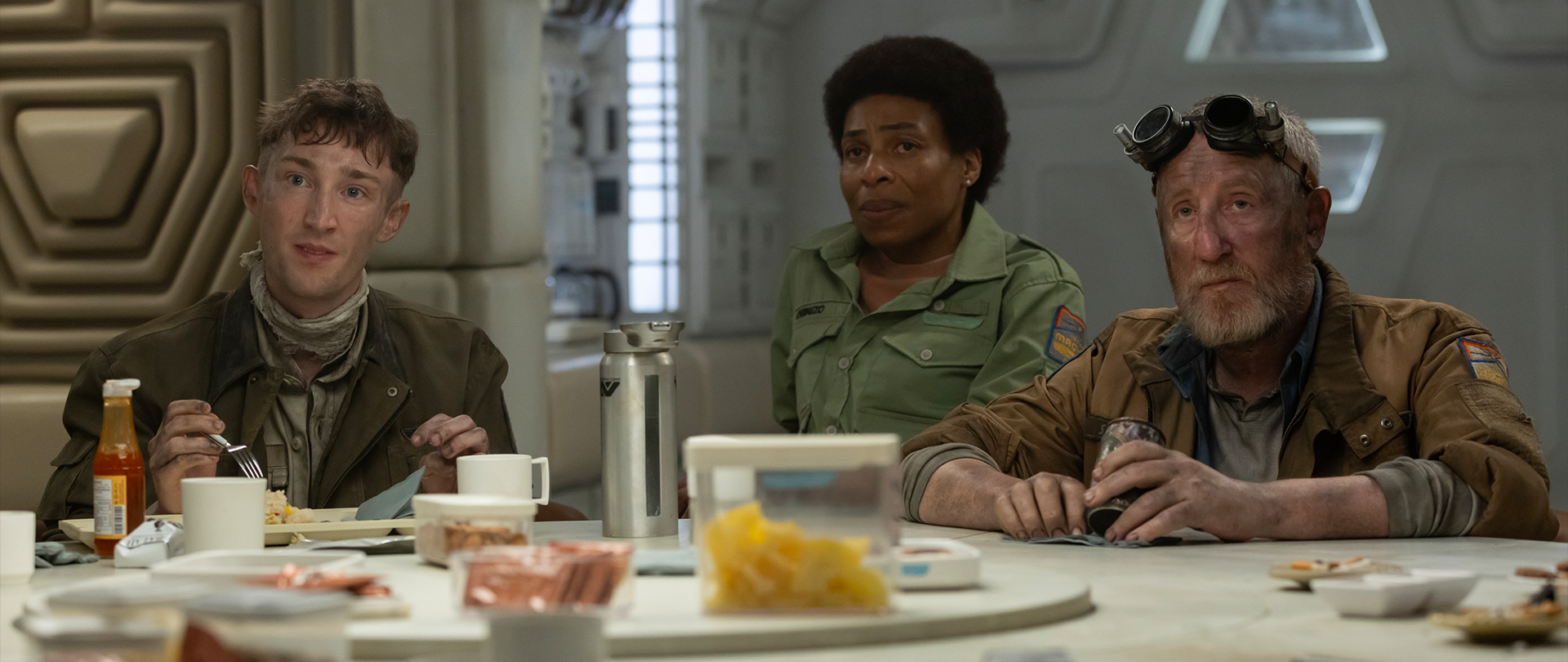 3 crew members of the USCSS Maginot sitting around the table in the galley