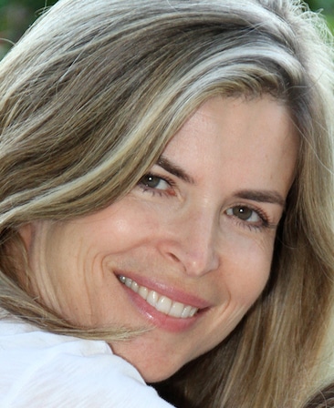 Gail Lyon headshot wearing a white shirt and looking over her shoulder