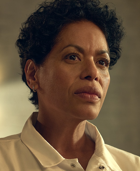 Liza Colón-Zayas headshot in FX's The Bear wearing a white collared shirt.