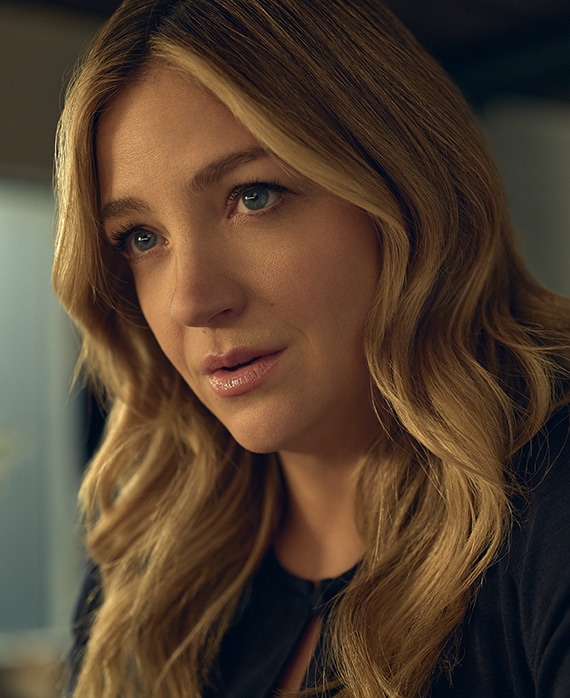 Abby Elliott headshot in FX's The Bear wearing a blue top.
