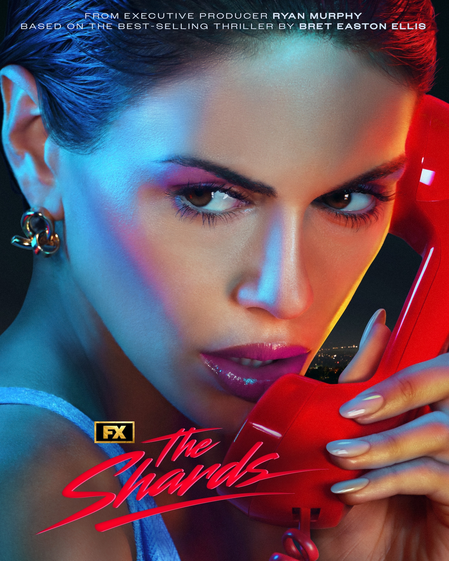 FX's The Shards Kaia Gerber picking up a red phone looking away from the camera with pink makeup and nude nails.