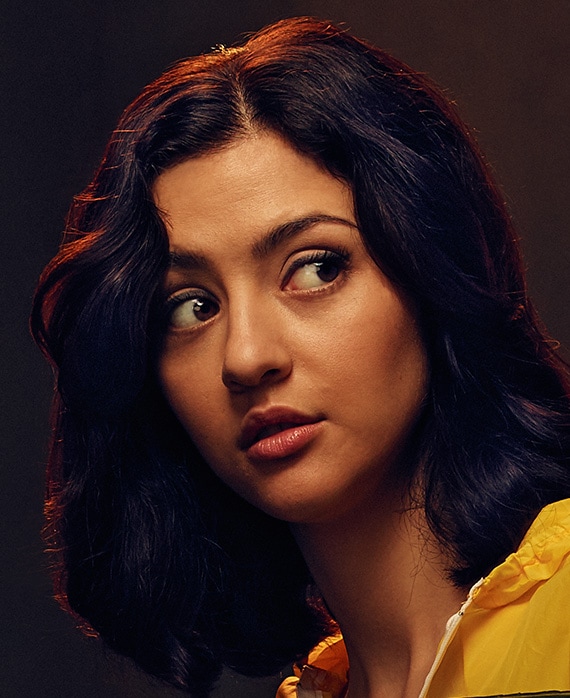 Katie Findlay headshot wearing a yellow top