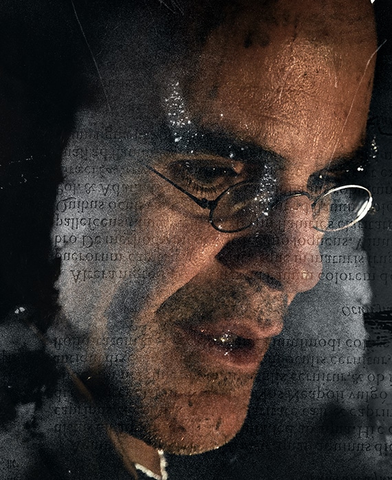 Michael Kelly Headshot wear small glasses and looking down