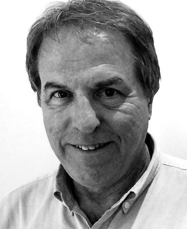 Gary Ungar Headshot wearing a collard shirt with a black and white filter