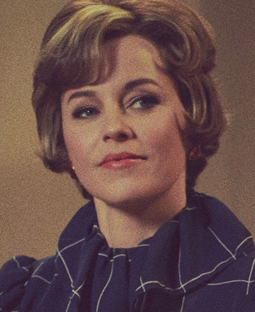 Elizabeth Banks headshot wearing a navy top with white lines