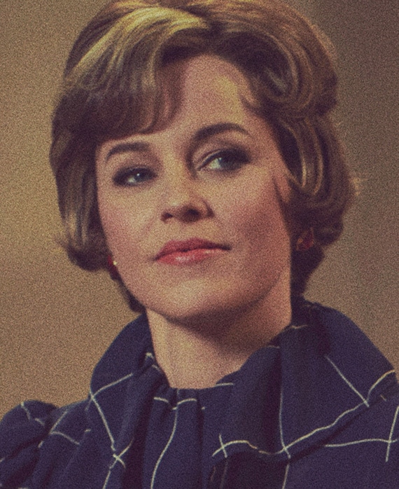 Elizabeth Banks headshot wearing a navy top with white lines