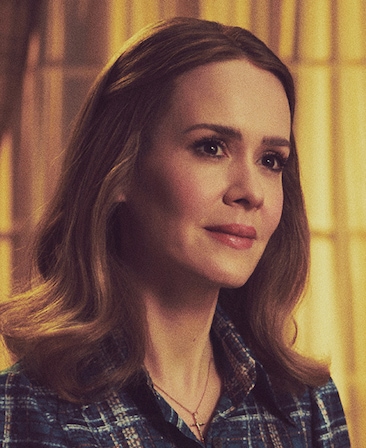 Sarah Paulson headshot wearing a plaid jacket and necklace