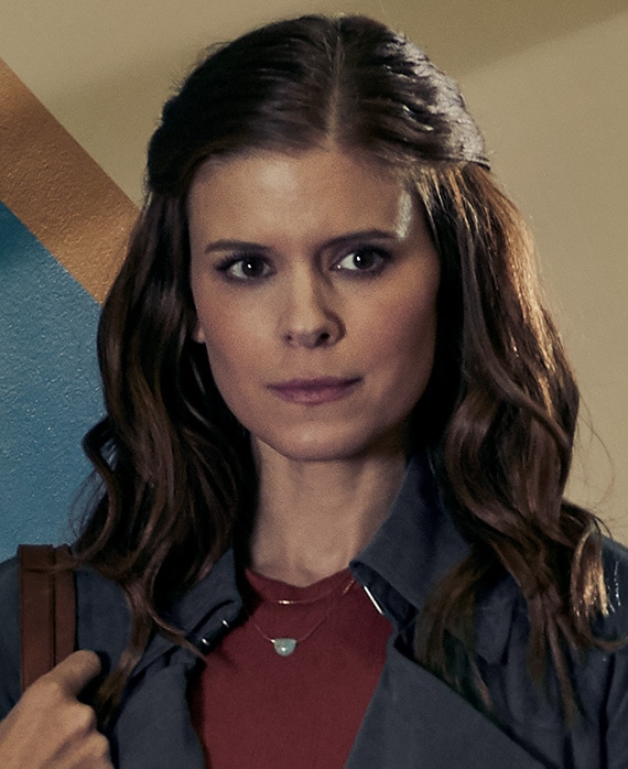 Kate Mara Headshot wearing a red shirt and black jacket 
