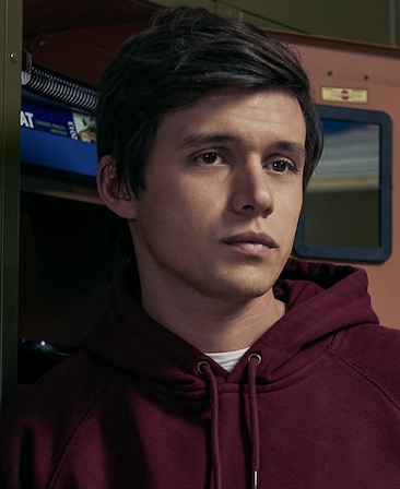 Nick Robinson Headshot wearing a red hoodie