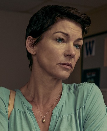 Rya Ingrid Kihlstedt Headshot wearing a green shirt and turning her head to the side