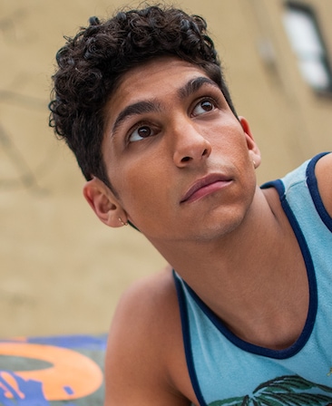 Angel Bismark Curiel headshot wearing a blue tank top 