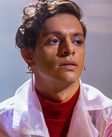 Jason Rodriguez headshot wearing a red top with a pink jacket