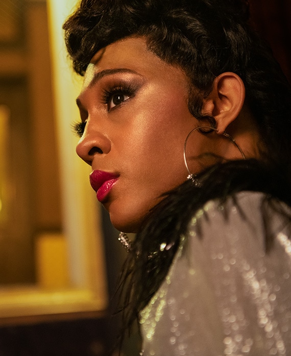 Mj Rodriguez headshot wearing a gray shirt and earrings