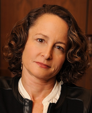Nina Jacobson headshot wearing a white shirt and black jacket