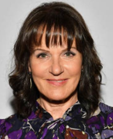 Sherry Marsh headshot wearing a purple blouse with a pattern