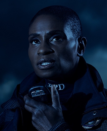Headshot of Adina Porter in police uniform holding receiver microphone under moonlight from FX's AHS Double Feature