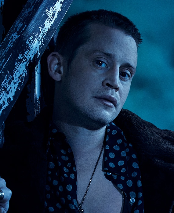 Headshot of Macaulay Culkin in open button down and jacket under moonlight on cloudy night from FX's AHS Double Feature