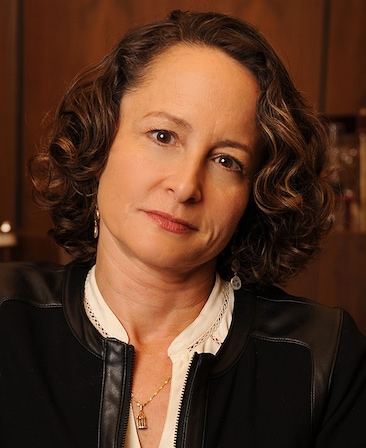 Nina Jacobson headshot wearing a white shirt and black jacket