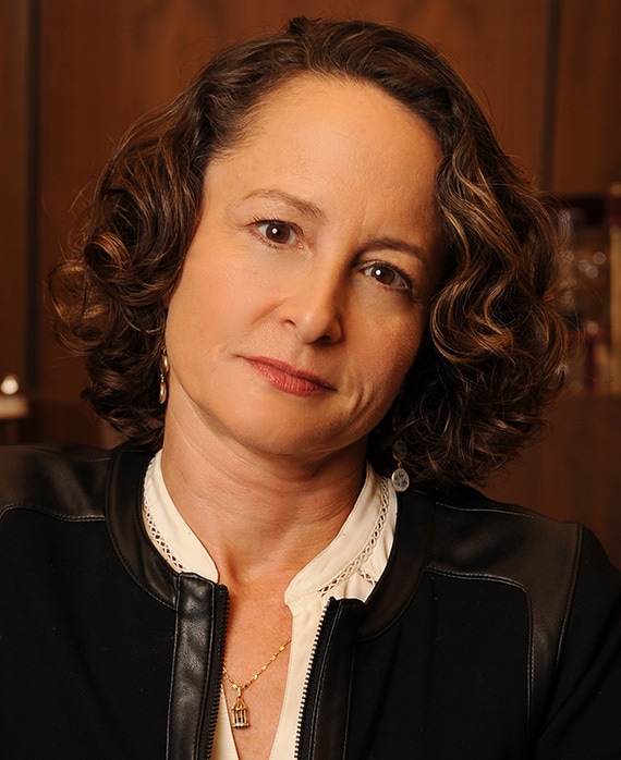 Nina Jacobson headshot wearing a white shirt and black jacket