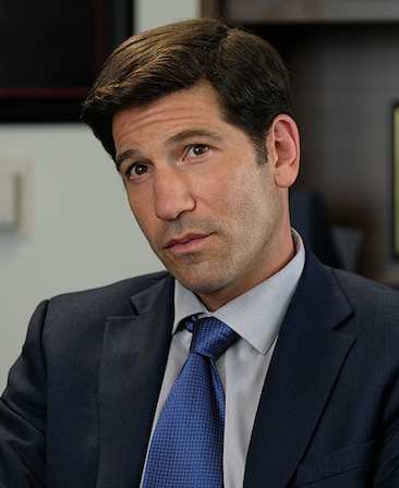 Jon Bernthal headshot wearing a navy tie and black suit jacket