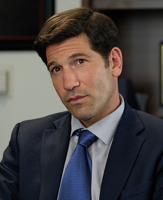 Jon Bernthal headshot wearing a navy tie and black suit jacket