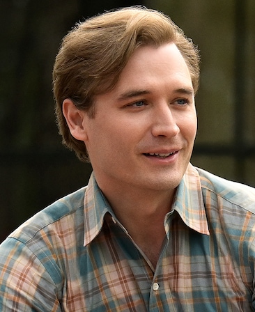 Seth Numrich headshot wearing a red and blue plaid shirt