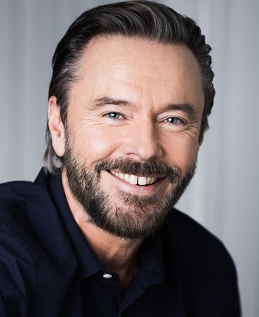 Craig Pearce headshot wearing a black shirt 