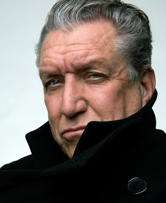 Steve Jones headshot wearing a big black coat covering his neck