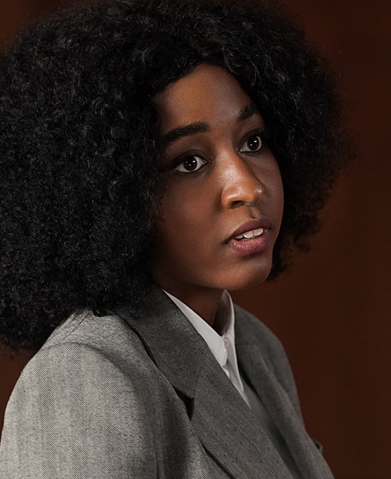 Ayo Edebiri headshot wearing a gray blazer jacket and white shirt