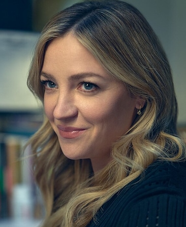 Abby Elliott headshot wearing a blue top.