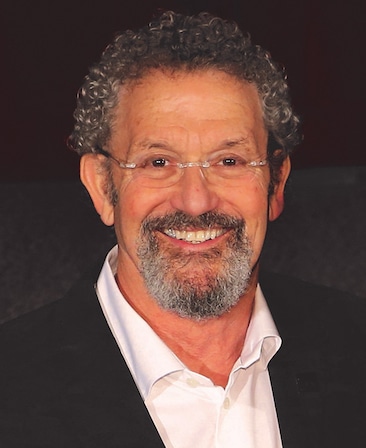 Thomas Schlamme Headshot wearing a white button down and black jacket