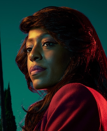 Devyn Tyler headshot wearing a red jacket 