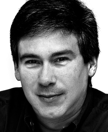 Christopher Keyser headshot in black and white wearing a black shirt