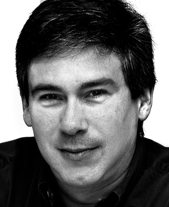Christopher Keyser headshot in black and white wearing a black shirt