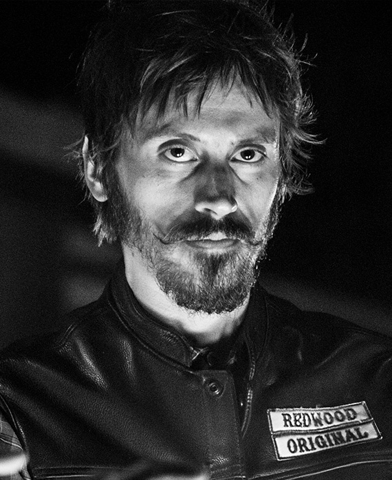 Niko Nicotera headshot wearing a "redwood original" leather jacket