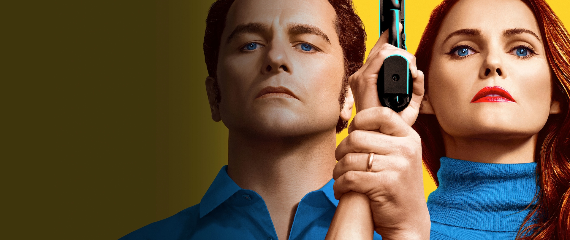 Man and woman, both with blue eyes, fair skin and reddish hair, facing forward standing side-by-side with woman holding a gun