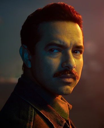Alejandro Edda headshot turning head side to the side and wearing a black jacket