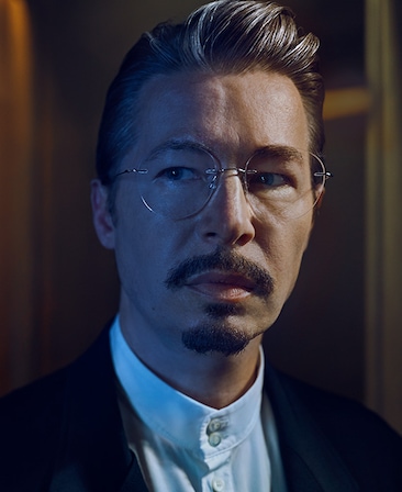 Edoardo Ballerini headshot wearing glasses and a white button down 
